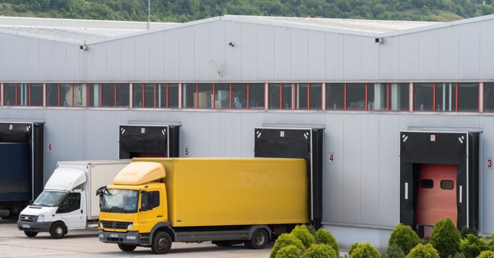 Delivery truck at warehouse dock; part of drayage services.